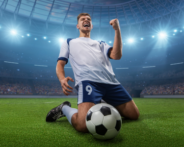 Football player celebrates a victory on the professional stadium